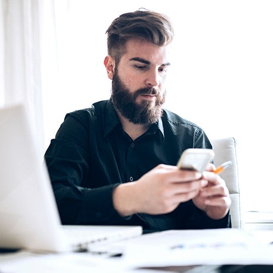 man looking into her mobile