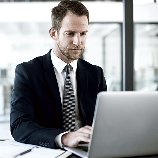 man looking into a screen 