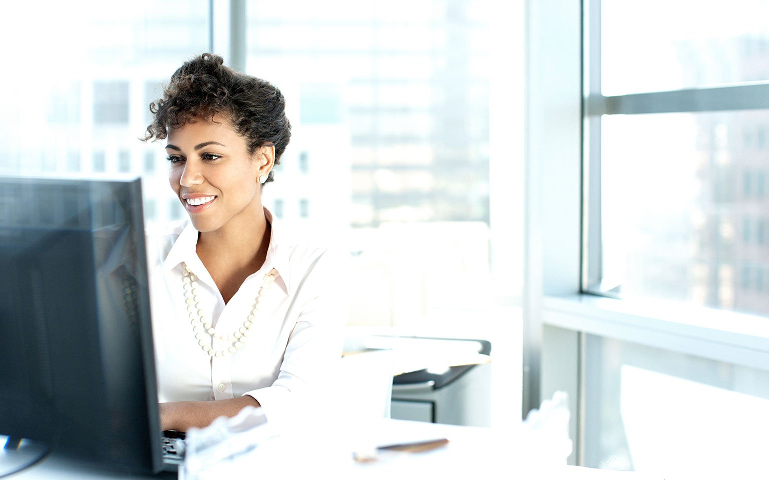 woman working on a desktop computer