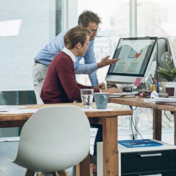 men working at a computer in an office