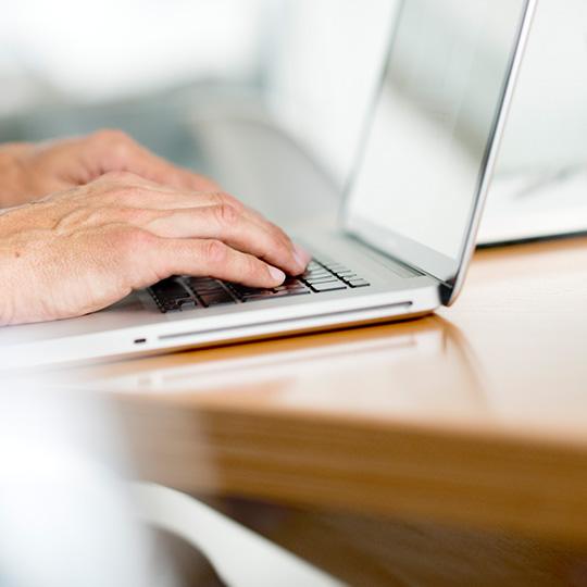 Veri güvenliğinde en yüksek standartlar close up of hands typing on a laptop