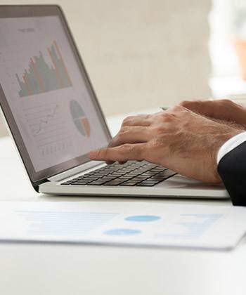 Kazanç close up of hands typing on a laptop keyboard