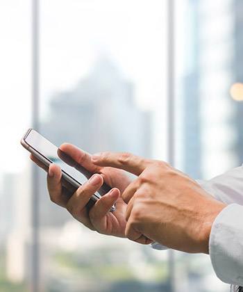 close up of hand texting on a smartphone