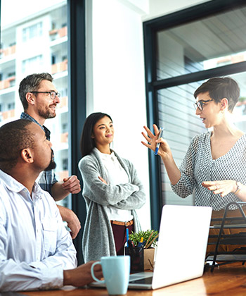 businesswoman explaining something to colleagues in a meeting